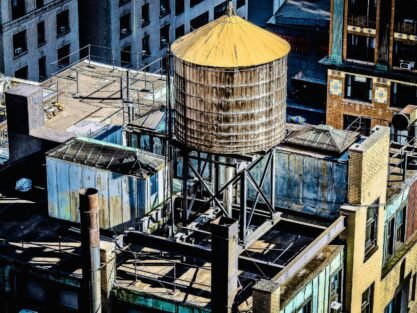 An amazing view of a downtown building roof with a water tank on it