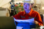 asian female engineer specialist with Measuring machine with a manipulator arm laptop.Three-dimensional coordinate measurement. Check sizes. 3D check of the sizes of parts.CMM after machining process